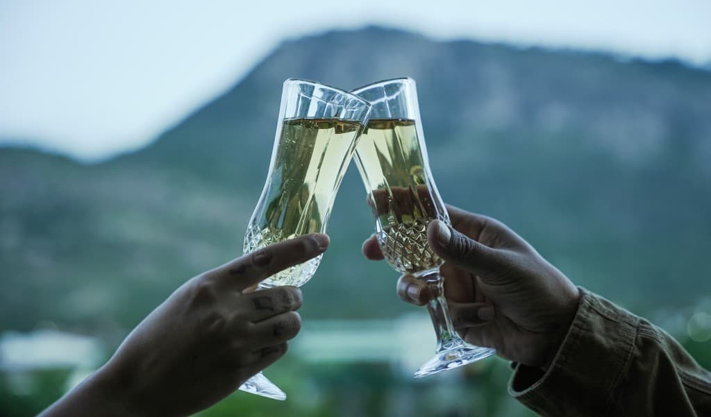 Champagne cheers with hills backdrop