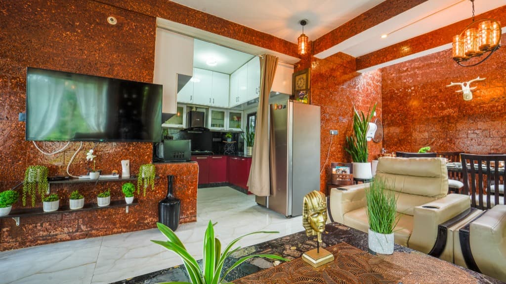 Living room with kitchen view and laterite walls